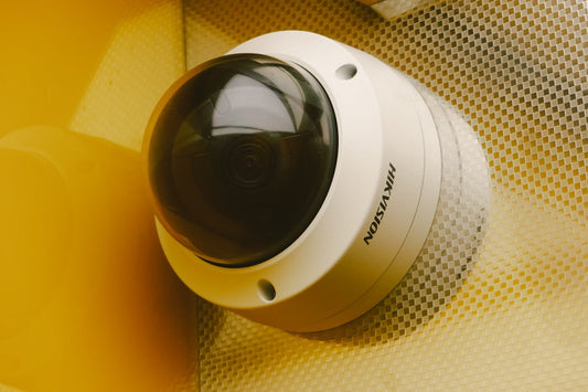 High-tech video surveillance camera mounted on a modern building wall, representing advanced security systems and 24/7 monitoring capabilities.